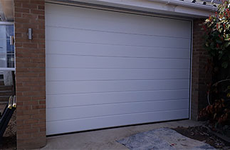 A Carteck Centre rib style white insulated sectional garage door. Fitted in Crowthorne, Berkshire.