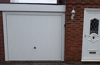 A Garador Carlton style steel up and over garage door door with a steel frame. Fitted in Ash, Hampshire.