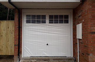 A Garador Salisbury style up and over steel garage door with a steel frame. One of Three fitted in Horsham, West Sussex.