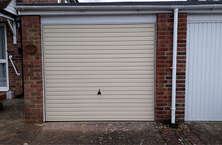 A Garador steel range up and over garage door in the Horizon style in Light Ivory with a white steel frame. Fitted in Bagshot, Surrey.