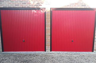 Two Garador Carlton style up and over garage doors in Red, With Burgundy steel frame and Rosewood PVC. Fitted in Woodley, Berkshire.