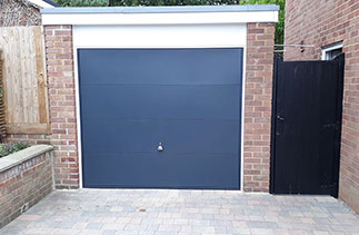 A Garador steel range up and over garage door from the design range. In the style 100, in Anthracite Grey with a White steel frame. Fitted in Camberley. Surrey.