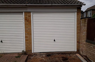 A Garador steel range up and over garage door. From the Guardian Range in the Horizon style. With a white steel frame. Fitted in Farnborough. Hampshire.
