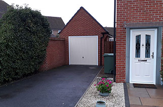 A Garador steel range up and over garage door in the Carlton style. In Light Ivory, with a white steel frame. Fitted in Basingstoke. Hampshire.