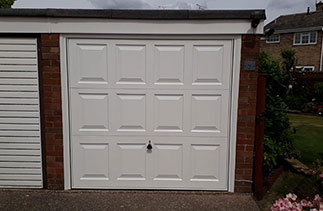 A Garador steel range up and over garage door in the Georgian style. In White with a White steel frame. Fitted in Farnborough. Hampshire.
