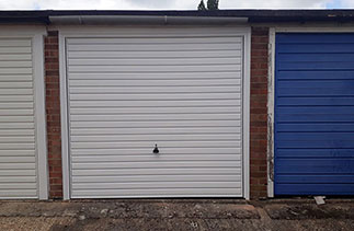 A Garador steel range up and over garage door in the Horizon style. In White with a White steel frame. Fitted in Aldershot. Hampshire.