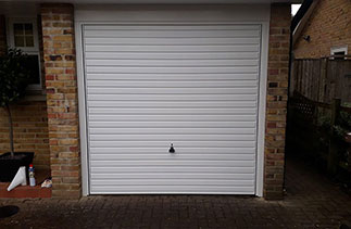 A Garador steel range up and over garage door in the Horizon style. In White with a White steel frame. Fitted in Camberley. Surrey.