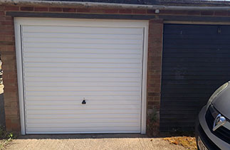 A Garador steel range up and over garage door in the Horizon style. In White with a White steel frame. Fitted in Farnborough. Hampshire.