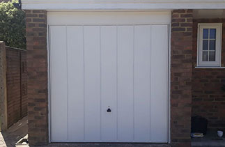 A Garador steel range up and over garage door in the Windsor style. In White with a White steel frame. Fitted in Sandhurst. Berkshire.