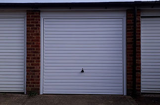 A Garador steel range up and over garage. In the Horizon style in White. With a White. Fitted in a block of Garages. Fitted in Woking. Surrey