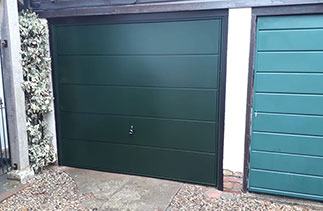 A Garador steel up and over garage door in the Ascot Style in Fir Green with Black Ash Pvc trims. Fitted in Henley On Thames. Oxfordshire.