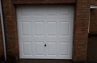 A Garador steel up and over garage door in the Georgian style in White. With a white steel frame. Fitted in Bracknell. Berkshire.