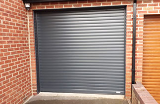 A Gliderol 77mm insulated Roller shutter garage door. In Anthracite Grey with matching guides and a matching full box. Fitted in Bagshot. Surrey.
