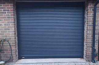 A Sws Seceuroglide compact roller shutter garage door. In Anthracite Grey with matching guides and a matching full box. Fitted in Guildford. Surrey.