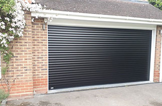 A Sws Seceuroglide Excel roller shutter garage door. In Black with White guides and a White full box. Fitted in Farnham. Surrey.