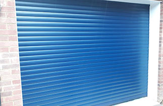 A Sws Seceuroglide Excel roller shutter garage door. In Navy Blue with White guides and a white full box. Fitted in Maidenhead. Berkshire.