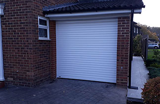 A Sws Seceuroglide Excel roller shutter garage door. In White with matching guides and a matching full box. Fitted in Frimley. Surrey.