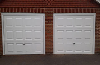 Two Garador steel range up and over garage door in the Georgian style. In White with White steel frames. Fitted in Camberley. Surrey.