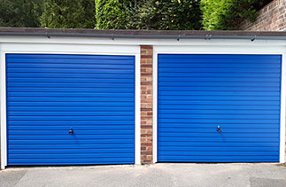 Two Garador steel range up and over garage doors in the Horizon style. In signal Blue with White steel frames. Fitted in Woking. Surrey.