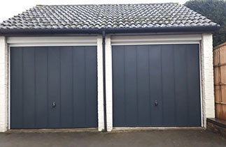 Two Garador steel range up and over Garage Doors in the Windsor style. In Anthracite Grey with White steel frames. Fitted in Guildford. Surrey.