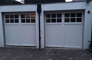 Two Woodrite timber up and over garage doors. From the Buckingham range, in the Birton style. Finished in White Ral. With matching hard wood frames. Fitted in Yatley. Hampshire.