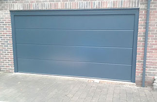 A Carteck 40mm insulated sectional garage door in the Solid Rib Style. In Anthracite Grey, Fitted in Woking, Surrey.