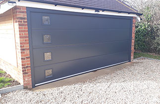 A Carteck Solid rib insulated sectional garage door with windows. Fitted near Hook Hampshire.