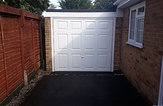 A Garador Beaumont style white up and over garage door. With a White steel frame, Fitted in Farnborough, Hampshire.