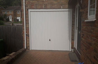A Garador Carlton style white up and over garage door. With a White steel frame and White PVC. Fitted in Lightwater Surrey