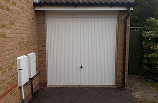 A Garador Carlton style White up and over garage door, with a White steel frame. Fitted in Bagshot, Surrey.
