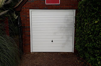 A Garador Horizon style White steel up and over garage door. With a White steel frame. Fitted in Westend, Surrey.