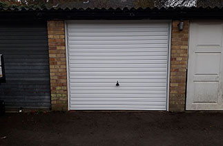 A Garador Horizon style White up and over garage door. With a White steel frame. Fitted in Addlestone, Surrey.