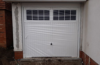 A Garador Salisbury style up and over steel garage door with a steel frame. One of Three fitted in Horsham, West Sussex.