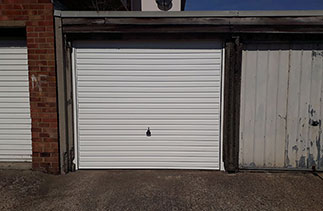 A Garador steel Horizon style up and over garage door in White with a White steel frame. Fitted in Bracknell, Berkshire