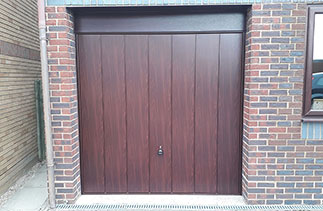 A Garador Steel range Sherwood style up and over garage door. In Rose Wood foil finish, With a Burgundy steel frame and a Rose Wood PVC fascia. Fitted in Westend, Surrey.