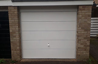 A Garador Windsor style White up and over garage door. With a White steel frame and a White handle. Fitted in Camberley, Surrey.