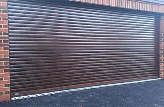 A Sws Seceuroglide Excel Roller Shutter Garage Door in Painted Walnut finish. Fitted in Windlesham. Surrey.