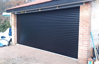 A Sws Seceuroglide Insulated Roller Shutter Garage Door in Black. Fitted in Chobham, Surrey