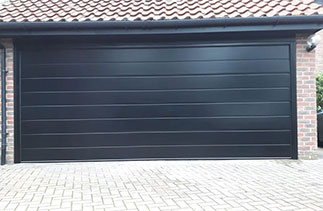 A Carteck 40mm insulated sectional garage door. In the Centre rib style. In a Black smooth finish. Fitted in Ascot. Berkshire.