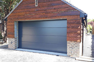A Carteck 40mm insulated sectional garage door. In the Solid rib style in Anthracite Grey smooth finish. Fitted in Guildford. Surrey.