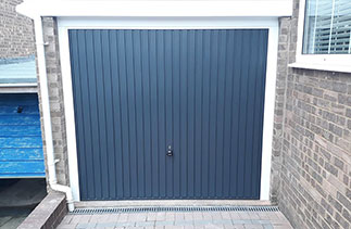 A Garador steel range up and over garage door in the Carlton style. In Anthracite Grey with a White steel frame. Fitted in Bordon. Hampshire.