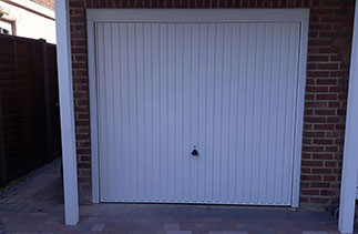 A Garador steel range up and over garage door in the Carlton style. In White with a White steel frame. Fitted in Bisley. Surrey.
