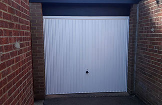 A Garador steel range up and over garage door in the Carlton style. In White with a White steel frame. Fitted in Sandhurst. Berkshire.