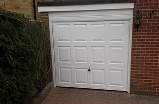 A Garador steel range up and over garage door in the Georgian style. In White with a White steel frame. Fitted in Camberley. Surrey.