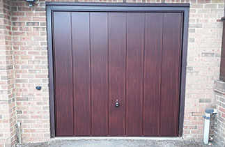 A Garador steel range up and over garage door in the Sherwood style. In Rosewood finish. Fitted to the existing timber frame. Fitted in Finchampstead. Berkshire.