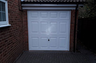 A Garador steel range up and over garage in the Beaumont style. In White with a White steel frame. Fitted in Windlesham. Surrey.