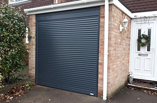 A Gliderol 55mm compact insulated roller shutter garage door. In Anthracite Grey with matching guides and a matching full box. Fitted in Bagshot. Surrey.
