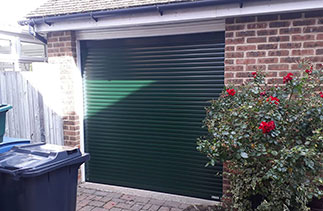 A Gliderol 55mm compact roller shutter garage door. In Green with matching guides and a matching full box. Fitted in Fleet. Hampshire.
