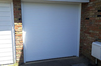 A Gliderol 55mm compact roller shutter garage door. In White with White guides and a White full box. Fitted in Lightwater. Surrey.