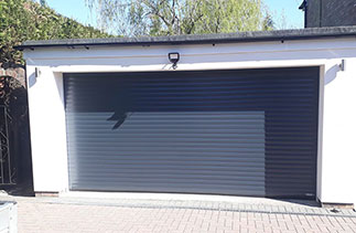 A Gliderol 77mm insulated Roller shutter garage door. In Anthracite Grey. With matching guides and a matching full box. Fitted in Camberley. Surrey.